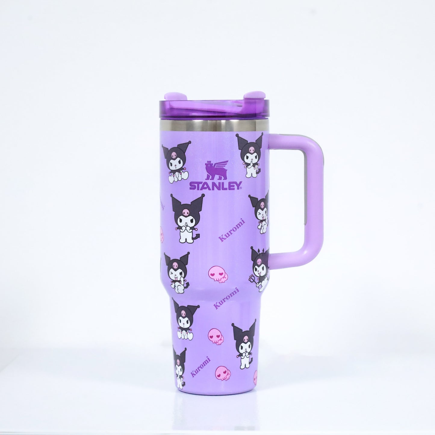 A purple Stanley-style tumbler featuring Sanrio’s Kuromi character and pink skull graphics, with a matching purple handle and lid.