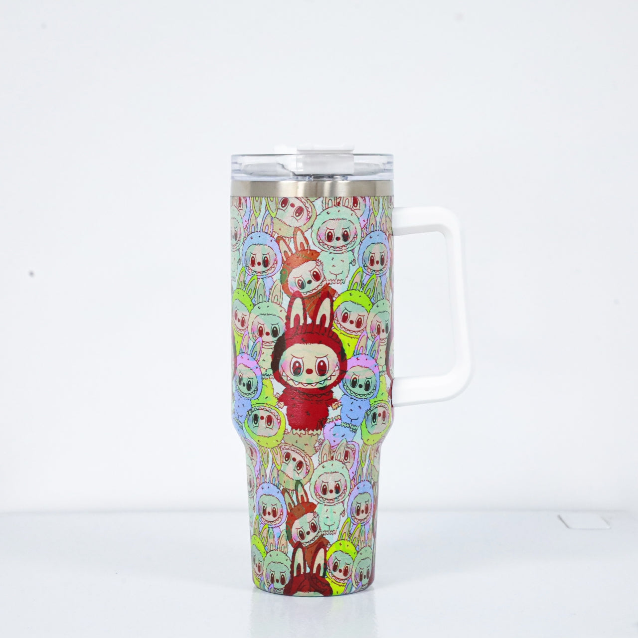 A stainless steel tumbler with a white handle, covered in a dense pattern of colorful Labubu characters dressed in bunny suits, with a central red bunny standing out.